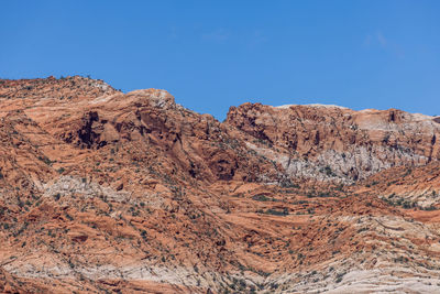 Rock formations against clear blue sky