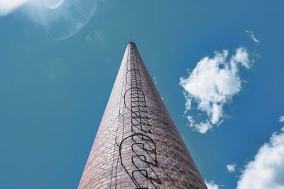 Low angle view of chimney against blue sky