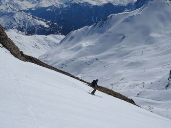 Person skiing on snowcapped mountain