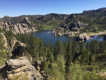 Scenic view of lake and mountains against clear sky