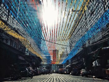 Illuminated city street against sky