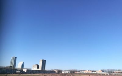 Cityscape against clear blue sky