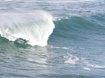 High angle view of waves splashing on sea
