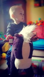 Boy holding toy at home