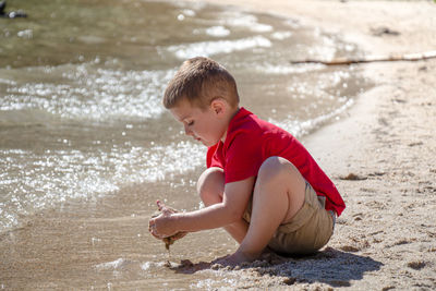 Boy playing in water at beach