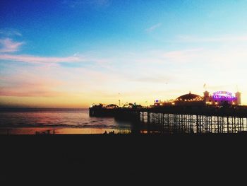 Silhouette pier on sea against sky during sunset