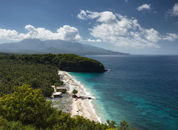 Aerial view of a tropical white sand virgin beach and turquoise water in karangasem, bali, indonesia