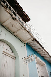 Low angle view of text on building against sky