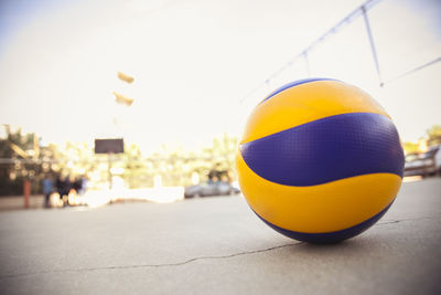 Close-up of ball on street against sky