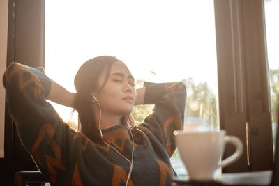 Young woman drinking coffee cup