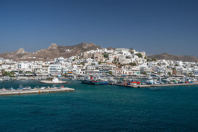 Boats in sea against clear sky