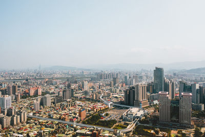 High angle view of modern buildings in city against sky