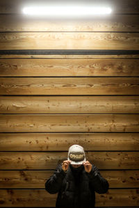 Full length of a man standing against wall