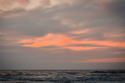 Scenic view of sea against romantic sky at sunset