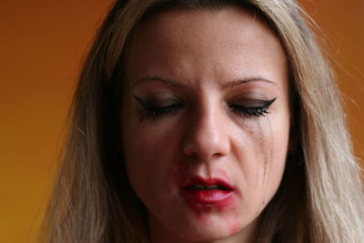 Close-up of sad woman with messy make-up