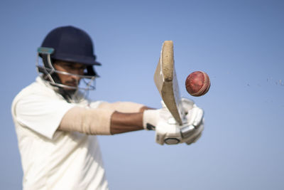 Cricketer playing cricket on the pitch in white dress for test matches. sportsperson hitting a shot