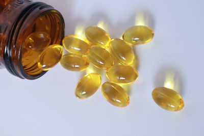 High angle view of yellow glasses on white background