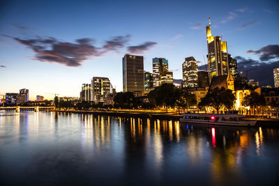 Illuminated buildings in city at waterfront