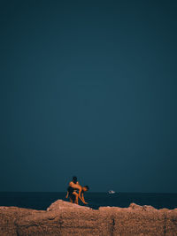 People at beach against sky