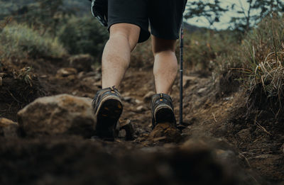 Low section of man standing on rock