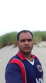 Portrait of young man standing on land