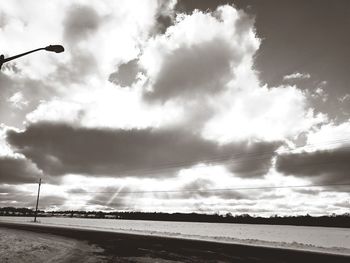 Low angle view of birds on beach against sky