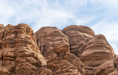 Low angle view of rock formations against sky