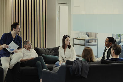 Group of business people having meeting in lobby