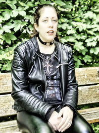 Portrait of young woman sitting outdoors