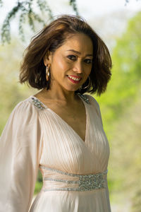 Portrait of smiling young woman standing outdoors