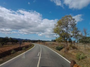 Empty road along countryside landscape