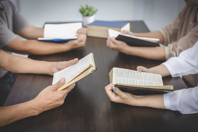 Midsection of woman reading book