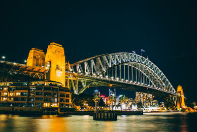 Illuminated bridge and buildings at night