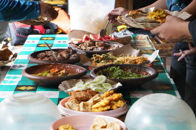 High angle view of people preparing food on table