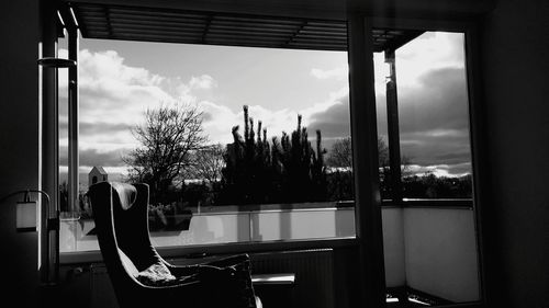 Rear view of man looking through window