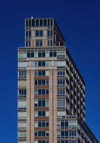 Low angle view of building against clear blue sky