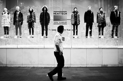 Full length of friends standing on wall