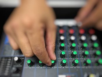 Close-up of person playing sound mixer