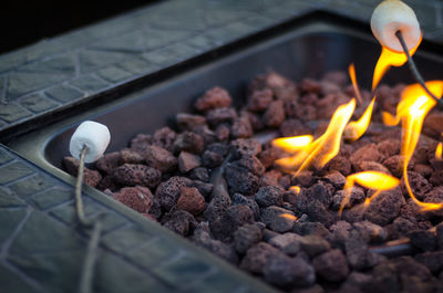 Close-up of marshmallows by fire pit