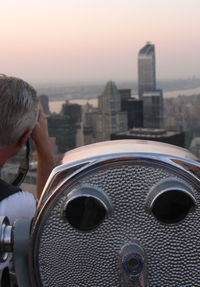 Close-up of cityscape against sky during sunset