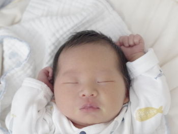 A sleeping asian baby in bed 