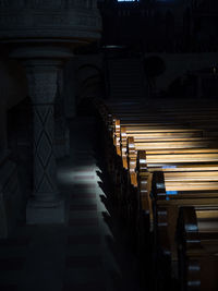 Empty aisle with cropped pews in row