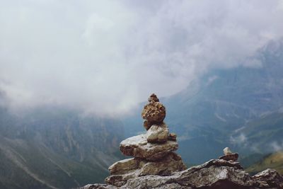 Statue on mountain against sky