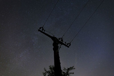 Low angle view of silhouette tree against sky at night