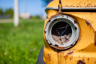 Old yellow wrecked car in vintage style. abandoned rusty yellow car. 