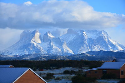 Houses on mountain against sky