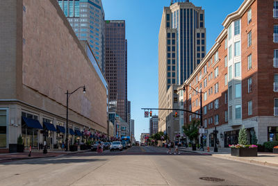 Street amidst buildings against sky in city