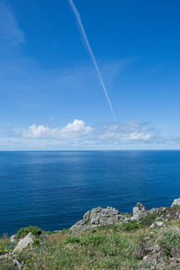 Scenic view of sea against blue sky