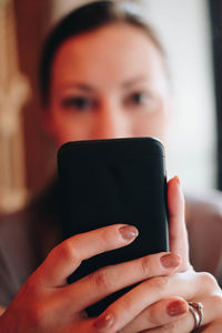 Portrait of woman holding mobile phone