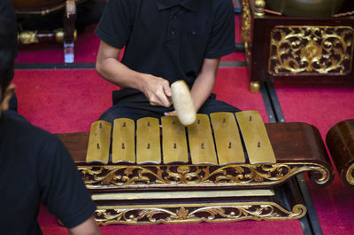 Midsection of man playing piano